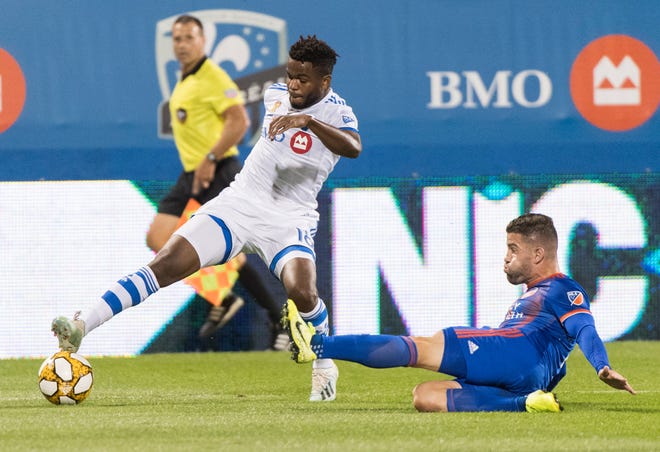 Montreal Impact's Orji Okwonkwo, left, challenges FC Cincinnati's Greg Garza during the first half of an MLS soccer match Saturday, Sept. 14, 2019, in Montreal. (Graham Hughes/The Canadian Press via AP)