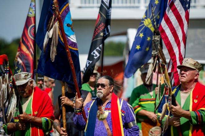 Head Veteran Barry Redbird Brown, center,  a retired Military Veteran of the 101st division of the US Army, along with members of the Ohio Valley Native American Veteran Warrior Society, leads dancers through the eastern door in the Grand Entry to signal the official opening of the Bluff City Pow Wow at Rockport City Park in Rockport, Ind., Sunday afternoon, Sept. 15, 2019.