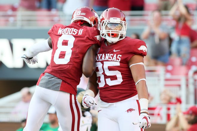 Arkansas Razorbacks tight end Cheyenne O'Grady (85) celebrates with wide receiver Mike Woods II (8) after scoring a touchdown against the Colorado State Rams in the fourth quarter at Donald W. Reynolds Razorback Stadium  Saturday, Sept. 14, 2019.