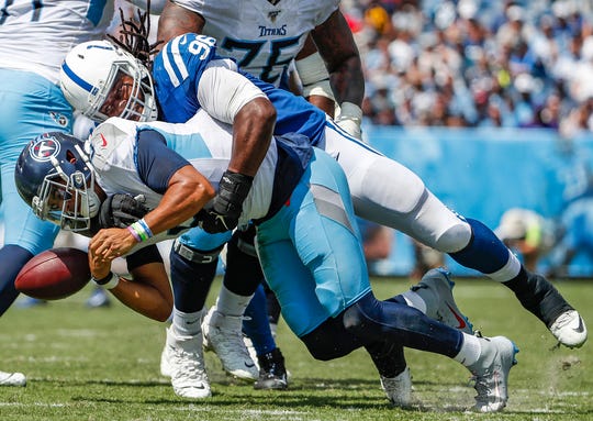 Indianapolis Colts defensive sacks Denico Autry (96) tackles Tennessee Titans quarterback Marcus Mariota (8) who fumbles the ball in the second quarter of their game at Nissan Stadium in Nashville, Tenn., on Sunday, Sept. 15, 2019. The Tennessee Titans recovered the fumble.