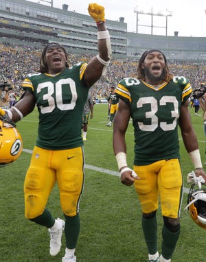 Green Bay Packers running back Jamaal Williams (30) and Green Bay Packers' Aaron Jones (33) leave the field following the Packers' victory over the Minnesota Vikings during their football game Sunday, August 15, 2019, at Lambeau Field in Green Bay, Wis.