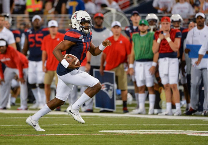 Sep 14, 2019; Tucson, AZ, USA; Arizona Wildcats quarterback Khalil Tate (14) runs the ball during the first half against the Texas Tech Red Raiders at Arizona Stadium. Mandatory Credit: Casey Sapio-USA TODAY Sports