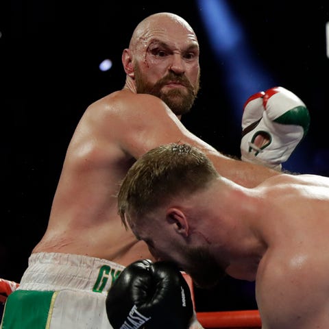 Tyson Fury, left, takes a swing at Otto Wallin.