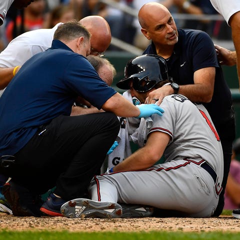 Charlie Culberson (8) is looked at by Braves medic