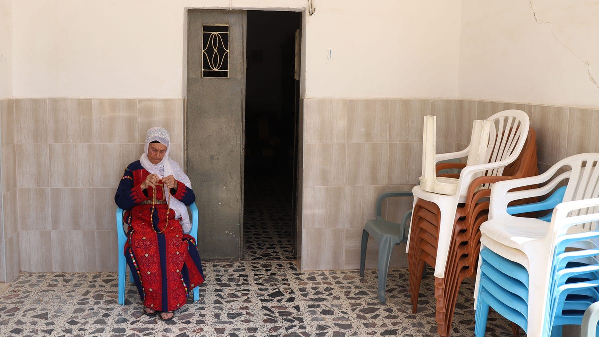 Muftiya Tlaib, Rep. Rashida Tlaib's grandmother, sits on the front porch of her home in Beit Ur Al-Fauqa, a village in the West Bank, on Sept. 10, 2019.