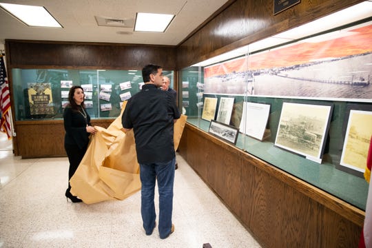 Nueces County Judge Barbara Canales and Nueces County Commissioner Brent Chesney unveil a display photos of Corpus Christi before the 1919 hurricane in the Nueces County Courthouse to commemorate the 100th anniversary of the 1919 storm on Monday, Sept. 16, 2019.