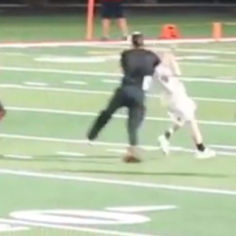 A student running on the field at a Wilmot High Sc