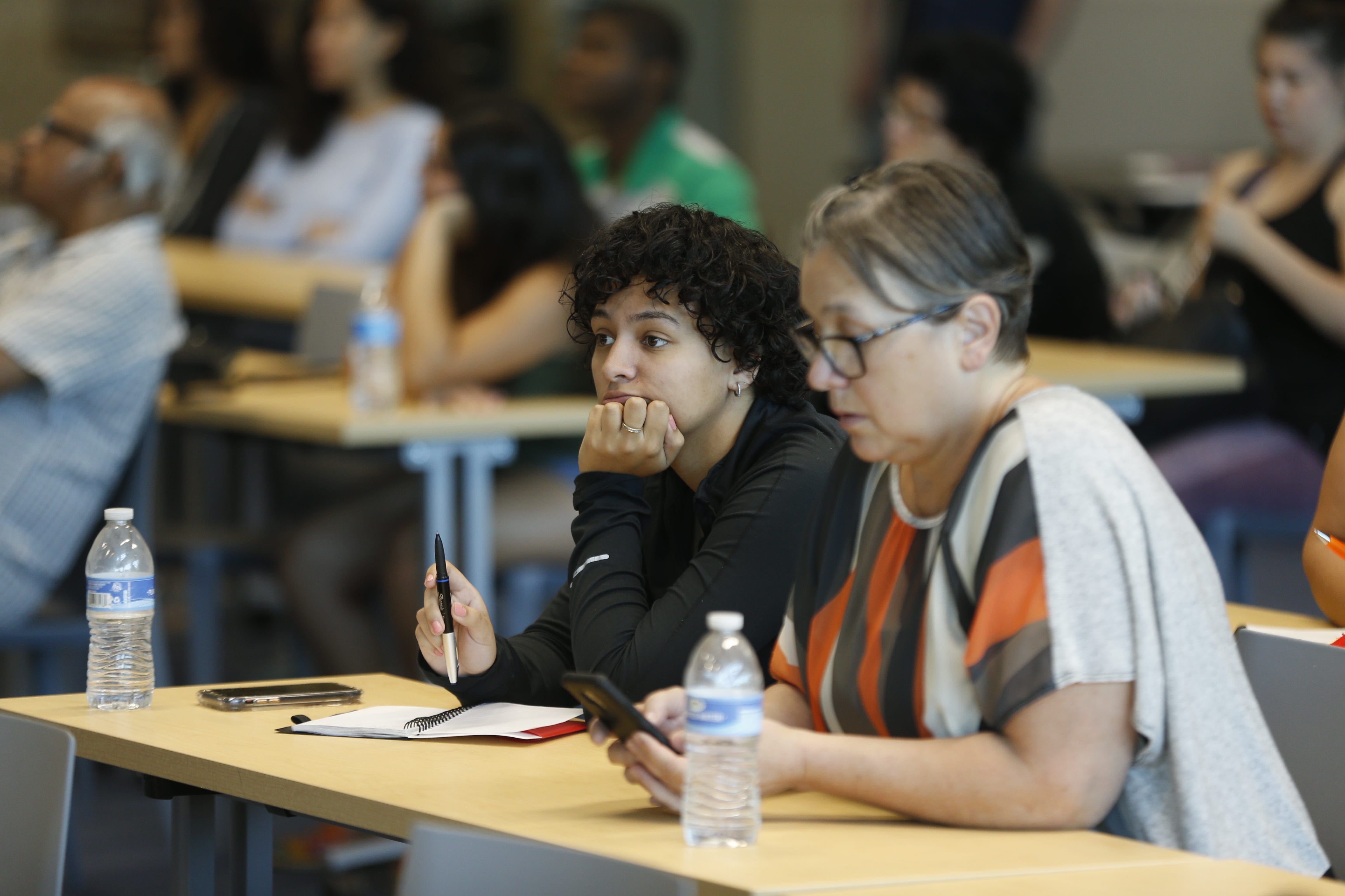 Students and parents attend a lecture helping with understanding the financial side of college during a College Depot event at the Burton Barr Phoenix Public Library in Phoenix on July 20, 2019.