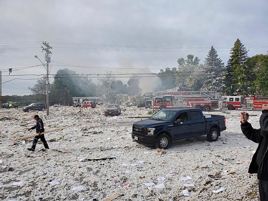 A man works at the scene of a deadly propane explosion on Sept. 16, 2019, which leveled new construction in Farmington, Maine. The explosion leveled a new building, which housed a nonprofit. 
