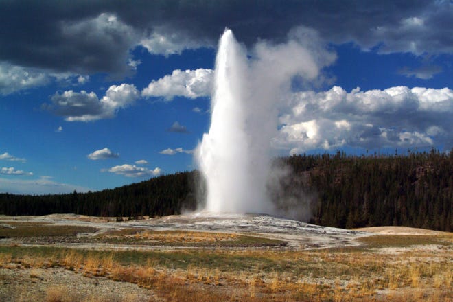 Old Faithful spews boiling hot water about once an hour.