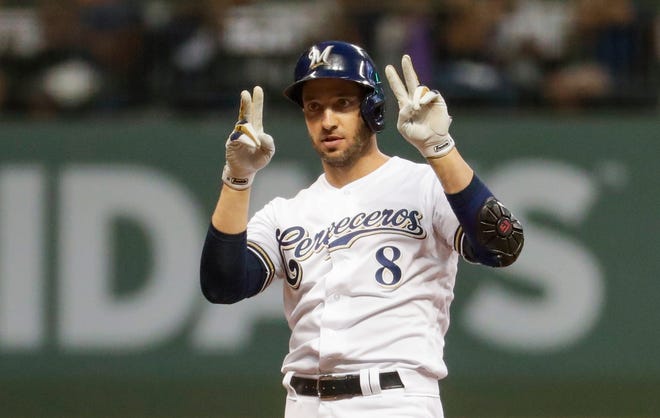 The Brewers' Ryan Braun gestures "22," a nod to injured  teammate Chrisian Yelich, after hitting a double in a recent game.