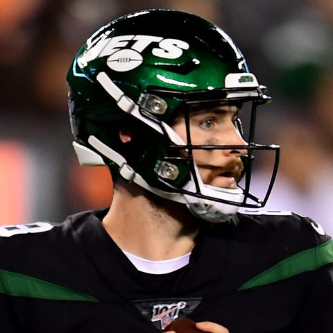 Luke Falk of the New York Jets drops back to pass 