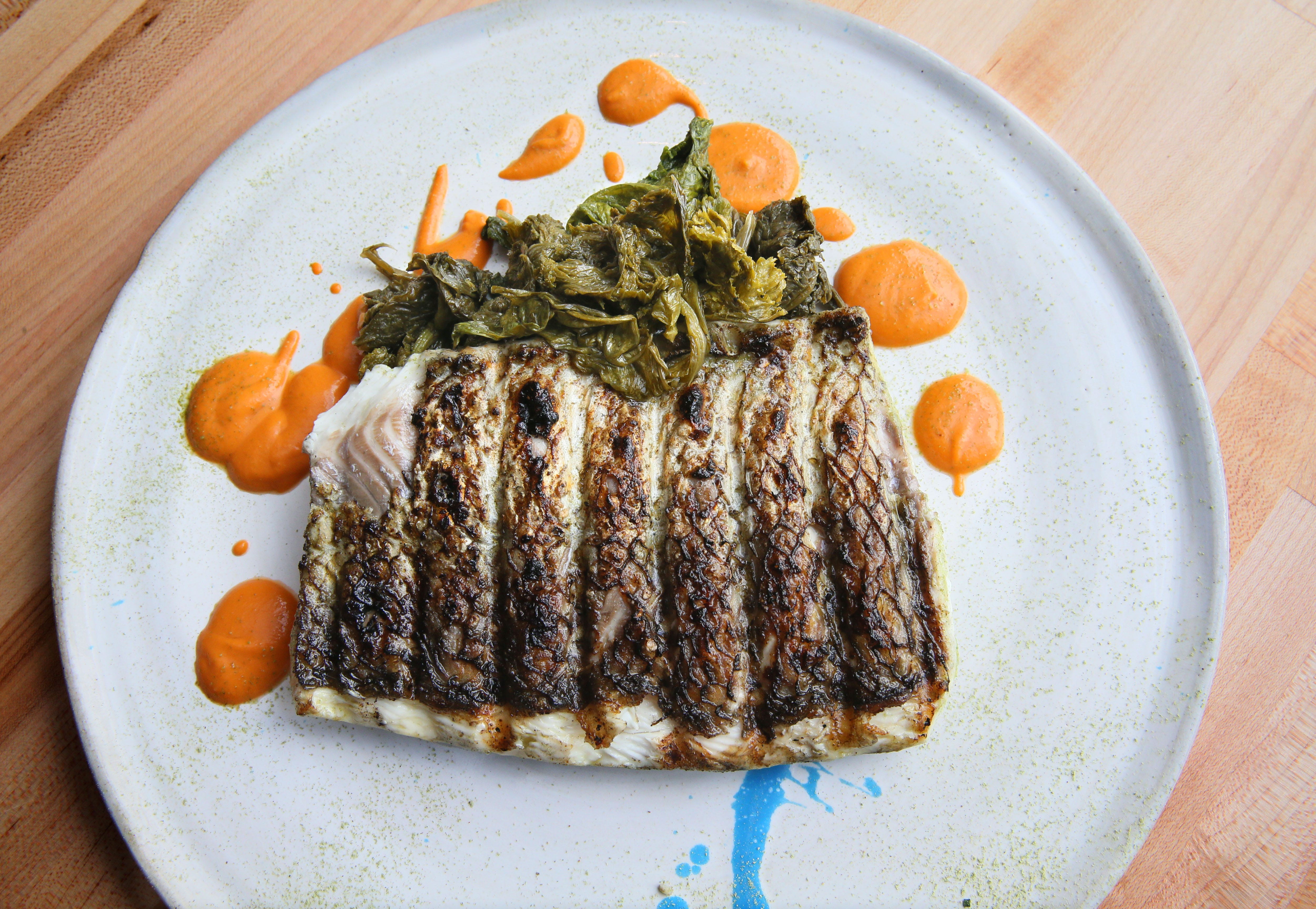 Birch + Butcher serves its grilled whitefish with tomato butter and kicky fermented mustard greens.