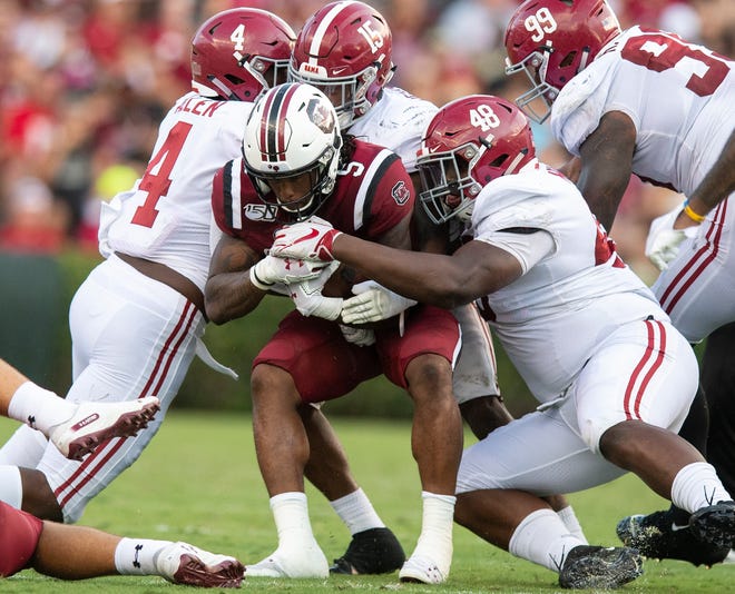 South Carolina running back Rico Dowdle (5) is stopped by Alabama linebacker Christopher Allen (4), defensive back Xavier McKinney (15) and defensive lineman Phidarian Mathis (48) at Williams-Brice Stadium in Columbia, S.C., on Saturday September 14, 2019.