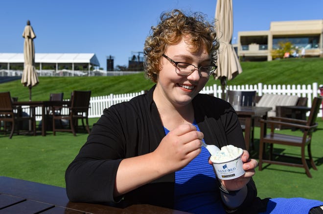 Argus Leader reporter Makenzie Huber samples the "Sanford Swirl" ice cream as she ranks the unique foods for fans at the Sanford International tournament.