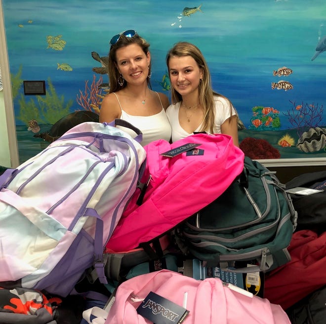 Ashby Taylor, left, and Michaela Miller recently delivered 40 backpacks filled with school supplies to the Hibiscus Children's Village in Vero Beach.
