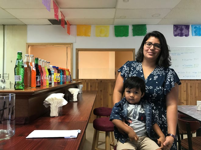 Owner Alejandra Rodriguez‐Nieto poses with her son at her family's new restaurant, Taqueria El Zebas. The Mexican restaurant is named after Rodriguez‐Nieto's two-year-old son, Zaiden Sebastian.
