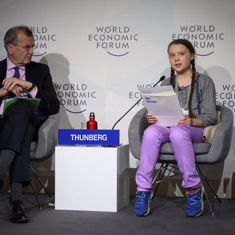 Greta Thunberg delivers a speech next to Governor 