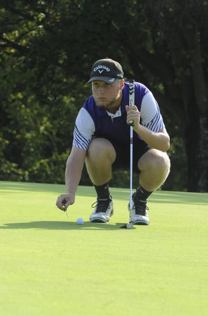 Unioto golf's Ty Schobelock marks his ball on the green at the Scioto Valley Conference No. 7 and No. 8 golf matches on Thursday September 19.