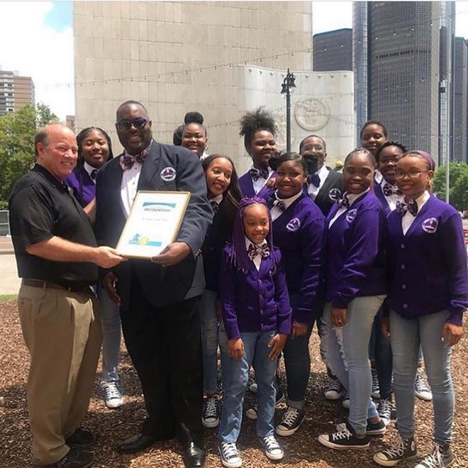 Mayor Mike Duggan left presents a certificate to Choir Director Anthony White of the Detroit Youth Choir earlier this year.