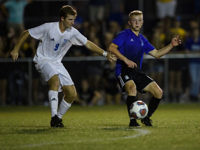 Castle’s Jackson Mitchell (12) keeps the ball from Memorial’s Cameron Jones (9) during the second half at Castle Soccer Stadium in Newburgh, Ind., Wednesday, Sept. 18, 2019.