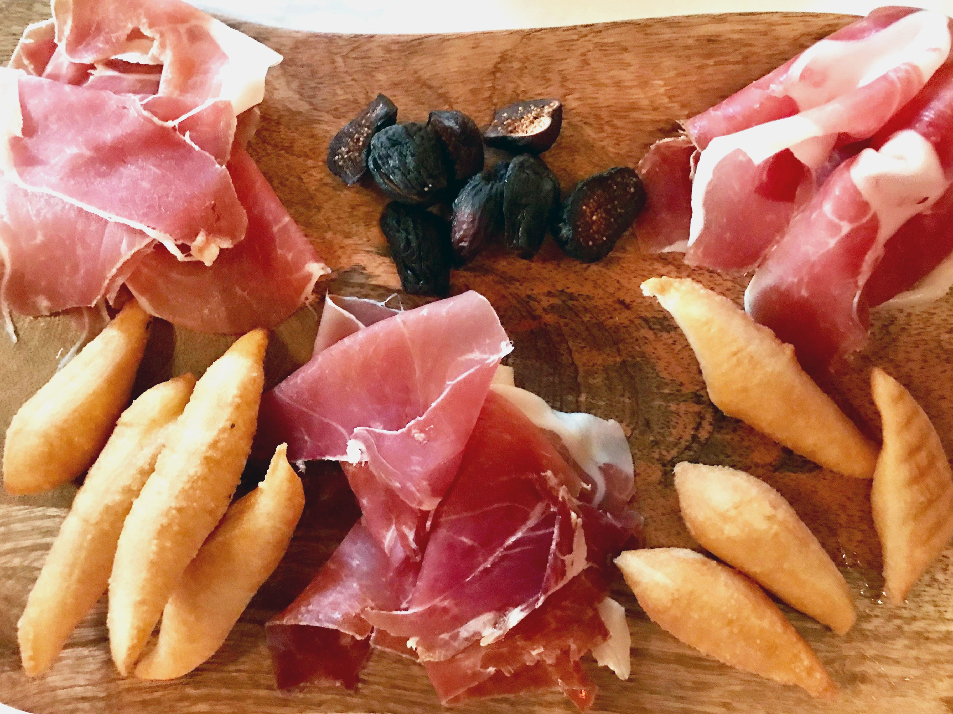 Antipasti at Ristorante Bartolotta in Wauwatosa included a board of three types of prosciutto with dried figs and gnocco fritto, little fried breads.