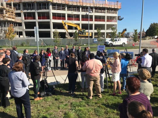 Mayor Lovely Warren announced the award of development rights Thursday to PathStone, which will partner with Geva on the seventh and final Eastern Inner Loop site. The new parking garage under construction at The Strong National Museum of Play is in the background.