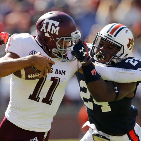 Texas A&M quarterback Kellen Mond is grabbed by Au