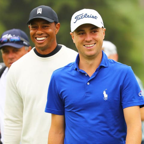 Tiger Woods, left, and Justin Thomas  during a pra