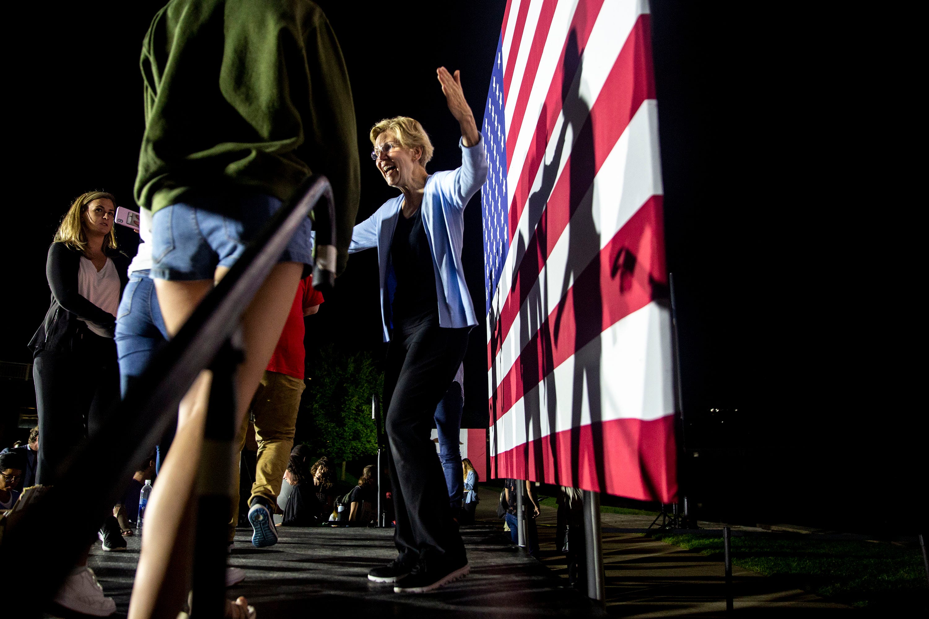 Members of the crowd gathered to listen to U.S. Sen. Elizabeth Warren, D-Mass., speak outside of the Iowa Memorial Union step up to meet her and take a selfie after a presidential campaign rally on Thursday, Sept. 19, 2019 on the University of Iowa campus in Iowa City. 