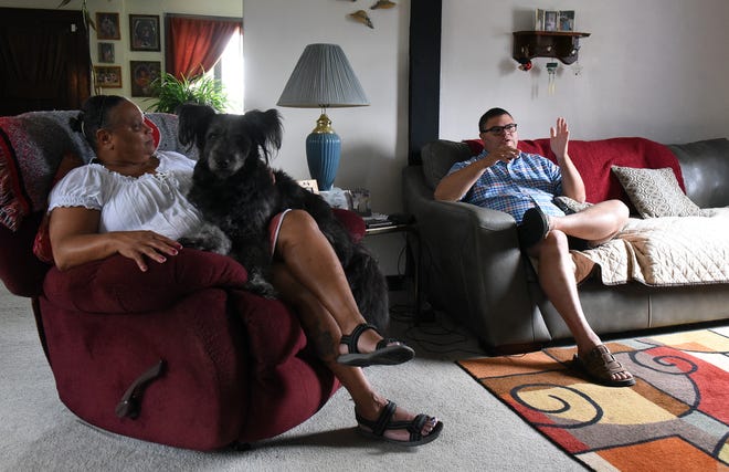 Desirée Blake sits with her son Jeremy Blake and family dog, Midnight, in the living room of her South Newark home. Growing up Jeremy remembers block parties and playing games with friends while living within two blocks of five generations of his family. That sense of community compelled Jeremy to enter the 2019 Newark mayoral race.