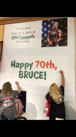 Fans sign the birthday card. Fans gathered to celebrate Bruce Springsteen's birthday at Stew Leonard's in Paramus Park Mall.