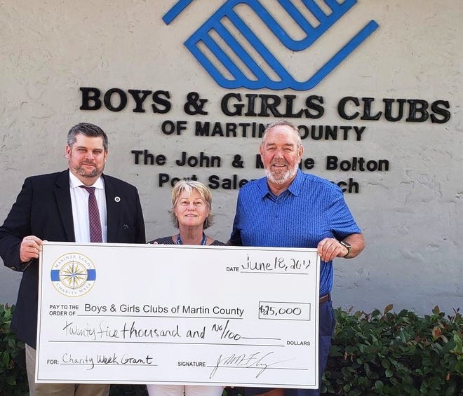 Martin County Boys & Girls Clubs President/CEO Keith “Fletch” Fletcher, left, accepts a $25,000 check from Guardian ad Litem/Mariner Sands resident Stephenie “Stevie” Chatellier and Mariner Sands Charity Week Chairman Jack Flanagan.
