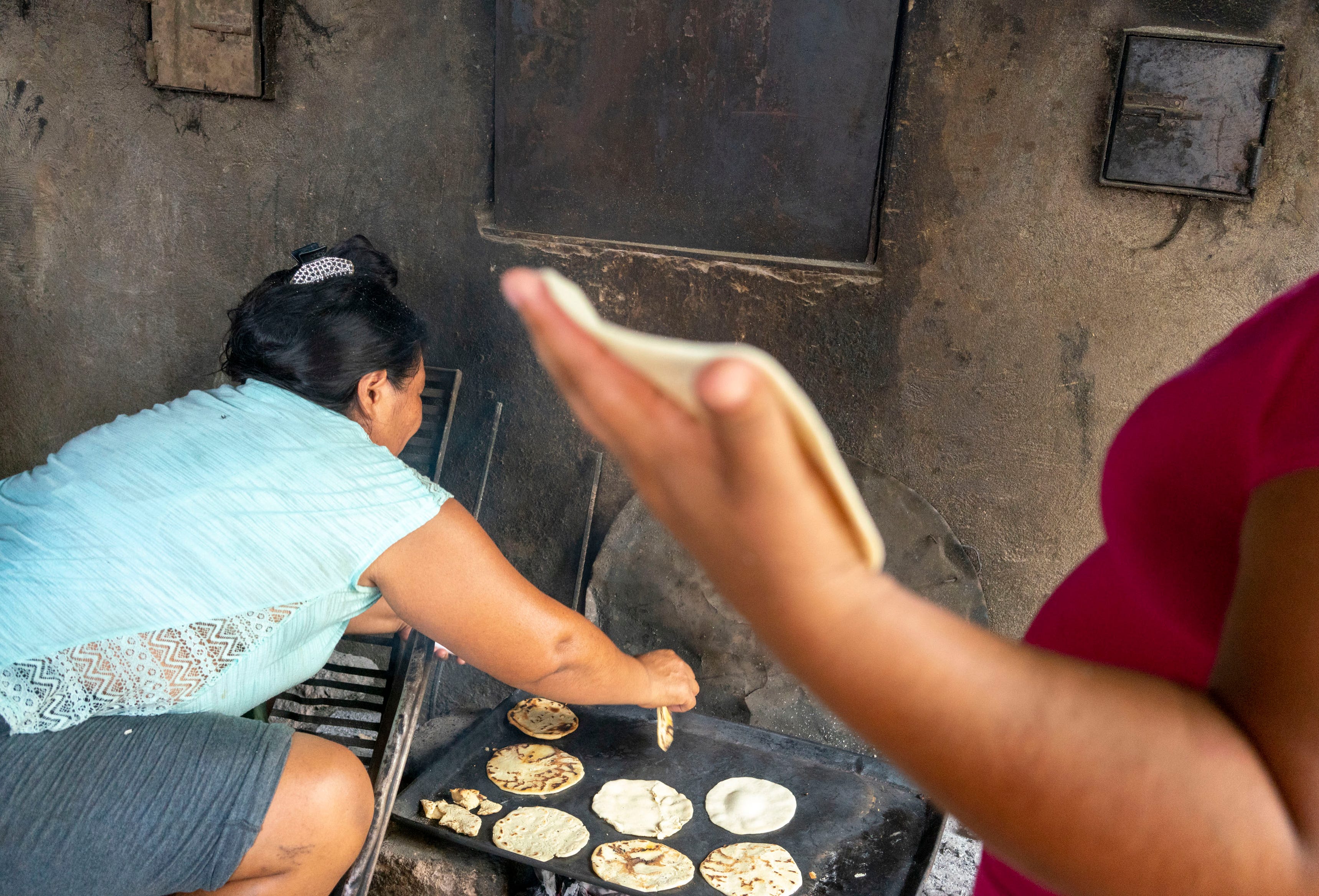 TAPACHULA, Mexico – Central American migrants make tortillas at the Jesus the Good Shepard Shelter for Migrants in Tapachula, Mexico, while they wait for a transit visa to go north toward the United States.