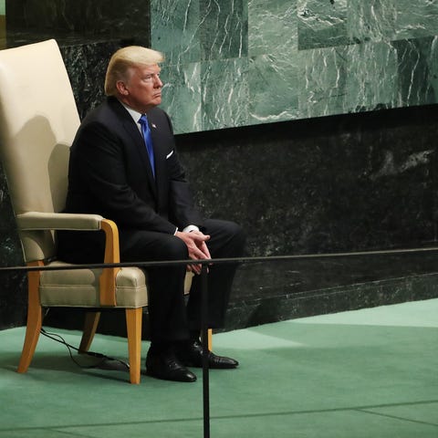 President Donald Trump sits in the head of state c