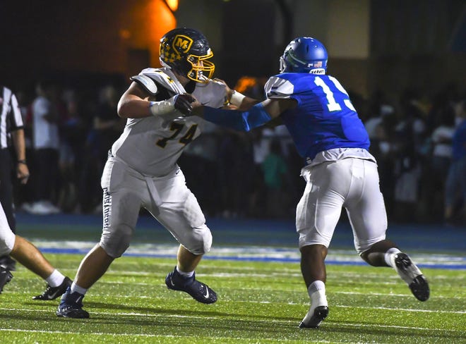 Landon Fickell (74) of the Moeller Crusaders blocks Will Whitson (15) of the Winton Woods Warriors on Friday, September 20, 2019, at Winton Woods High School in Forest Park, Ohio