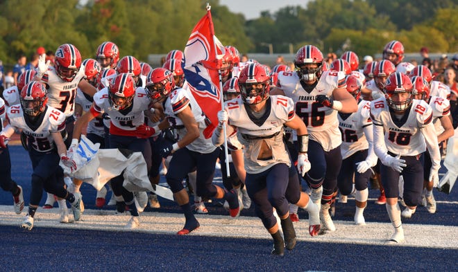 The Franklin Patriots run onto the field on Sept. 20.