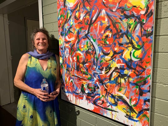 Barbara Wert, mother of David Bessent, poses for a photo in front of his artwork on Sept. 20, 2019.