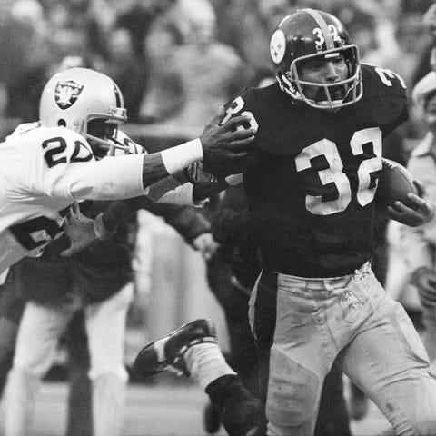 Franco Harris eludes a tackle by the Oakland Raide