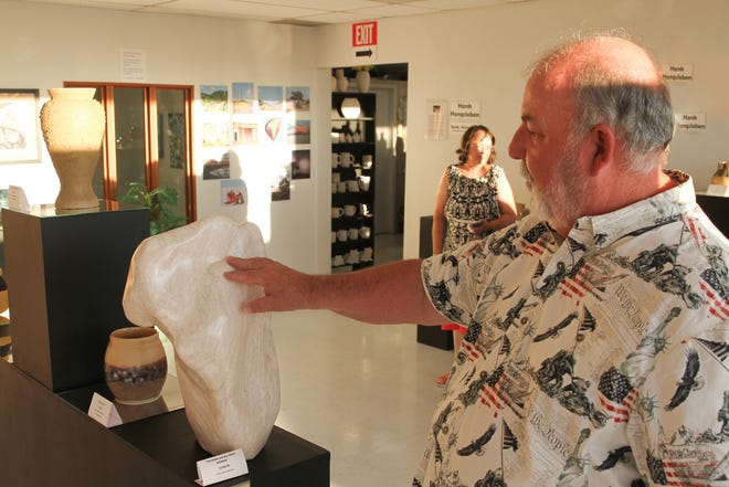 Artist and Clay Time Pottery and Ceramics owner Hank Hangsleben talks about his own artwork, which was displayed at a new fine arts gallery on Sept. 20.