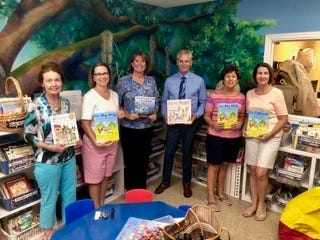 The Children’s Services Council of Martin County recently gave $5,000 of a $10,000 Walmart Foundation grant to Caring Children Clothing Children to buy curriculum materials for its Reading on Wheels program, which is lead by retired teacher Betty Mulligan. Pictured are, from left, Mulligan, Loreen Francescani, Laura Haase, David Heaton, Carol Allen and Jane Evans.