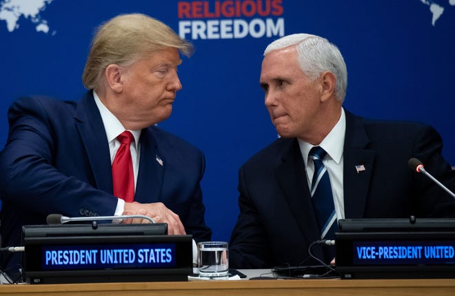 President Donald Trump shakes hands with Vice President Mike Pence at a United Nations event on Religious Freedom on Sept. 23, 2019.