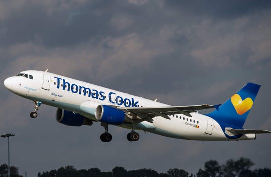  In this file photo taken October 11, 2014, an A320 airport bus by Thomas Cook takes off at Lille-Lesquin Airport, Northern France. British travel group Thomas Cook declared bankruptcy on September 23, 2019 after failing to reach a last ditch rescue deal, triggering Britain's largest homecoming since World War II to bring stranded passengers back. 
