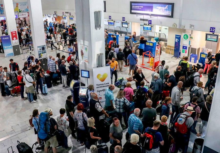 Tourists wait at a Thomas Cook company counter at Heraklion airport on the island of Crete on September 23, 2019. British travel group Thomas Cook declared bankruptcy on September 23, 2019, after failing to reach a last-ditch rescue deal, triggering the UK's biggest repatriation since World War II to bring back stranded passengers. The 178-year-old operator had been desperately seeking £200 million ($250 million, 227 million euros) from private investors to save it from collapse. 