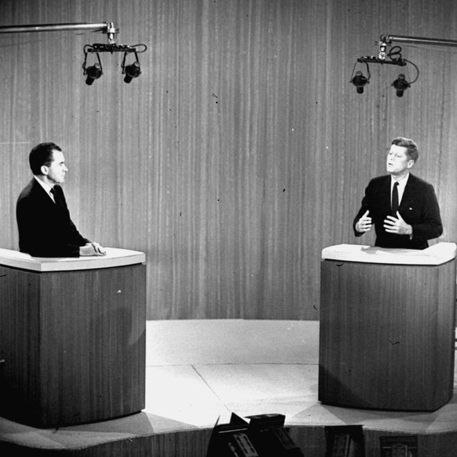 In this Oct. 21, 1960 file photo, Sen. John F. Kennedy, D-Mass., right, speaks and Vice President Richard M. Nixon listens during the fourth presidential debate from a New York studio.