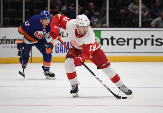Red Wings forward Filip Zadina skates with the puck ahead of the Islanders' Matt Martin during the first period of the Wings' 3-2 overtime loss to the Islanders in the preseason game on Monday, Sept. 23, 2019, in Uniondale, N.Y.