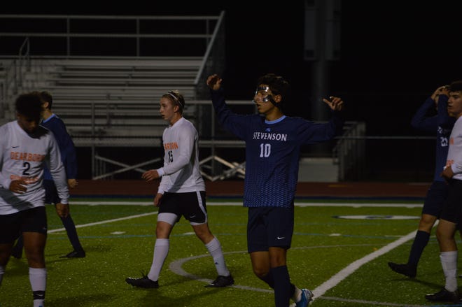 Livonia Stevenson senior forward Shaam Hammami reacts to a shot that nearly went in for the Spartans