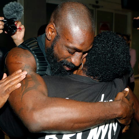 Wendell Brown hugs relatives after his arrival at 