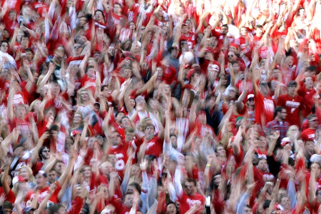 Students jump up and down to the song "Jump Around" at Camp Randall Stadium in Madison.