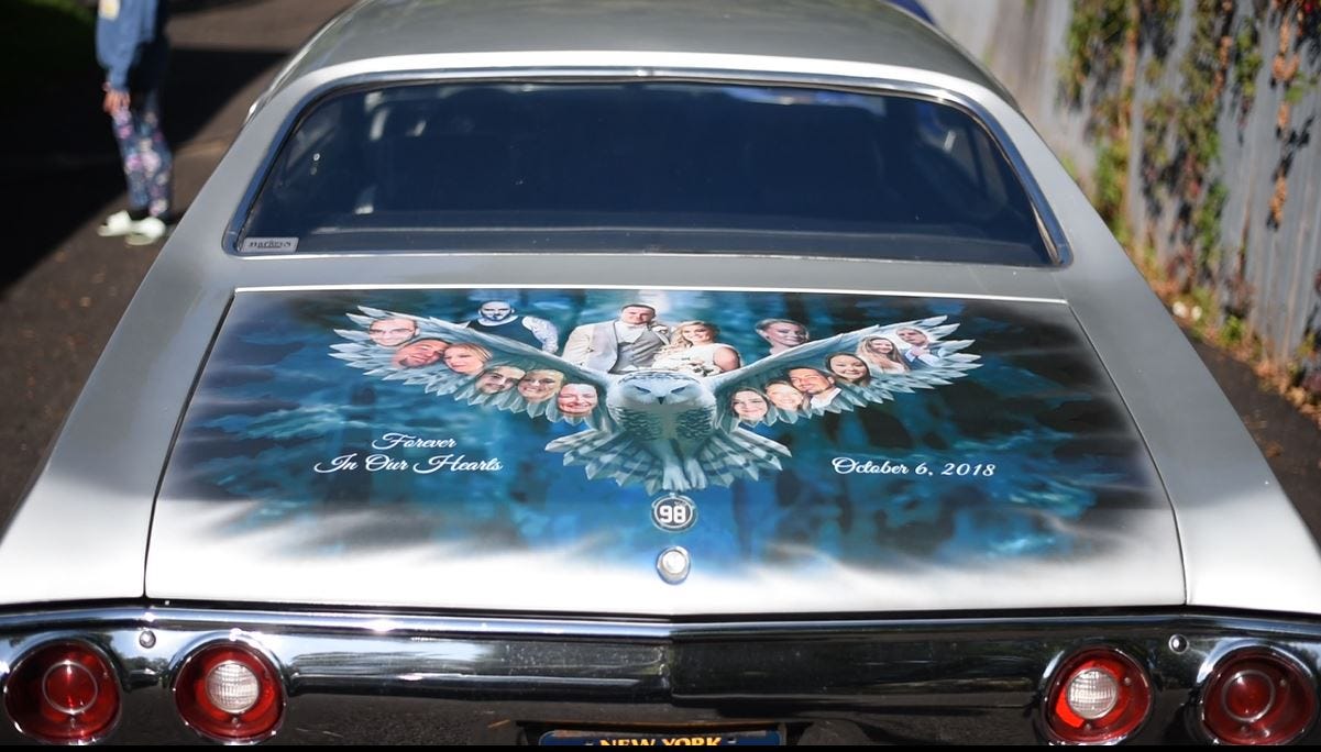 Dutch Andrews' and Janet Steenburg's 1971 Chevrolet Chevelle has an illustrated decal wrapped on its back end that honors the lives lost in the Oct. 6, 2018 limousine crash in Schoharie, New York. The decal shows the faces of 16 friends who died in the crash spread out across the wings of an owl, and includes the number 98 as an ode to another victim's jersey number.